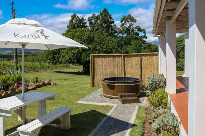 Wooden hot tub and umbrella in the garden