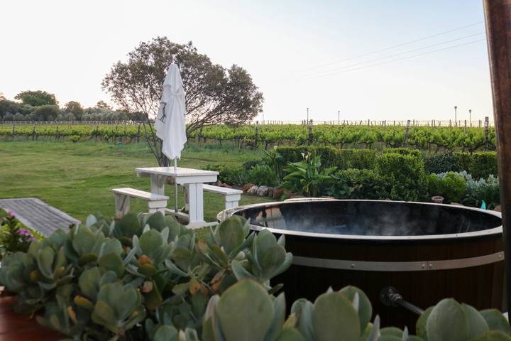 Wooden hot tub with the vineyard beyond