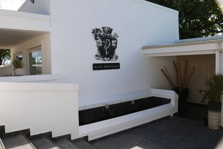 Du Vin entrance with a crest on the wall