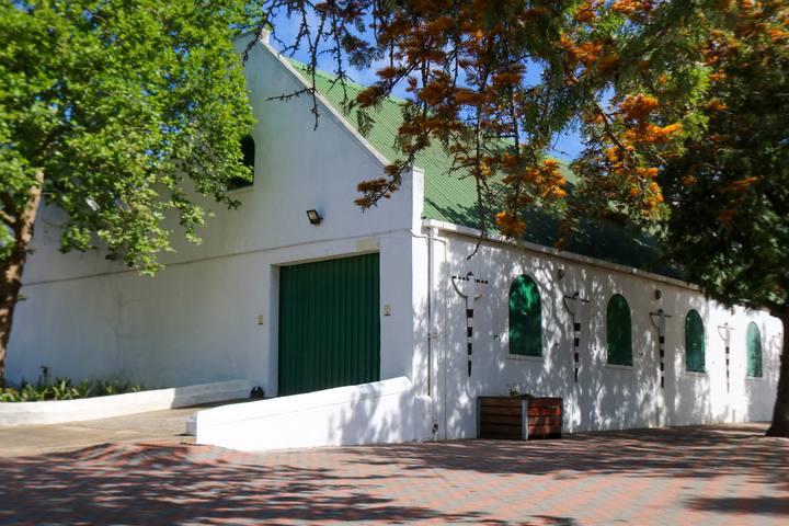 The long whitewashed cellar building