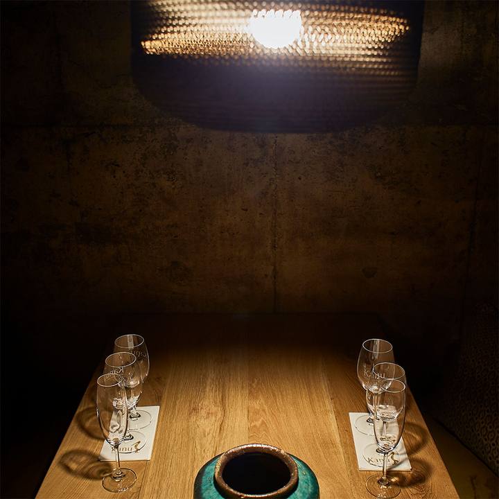 Spotlit tasting table set for two