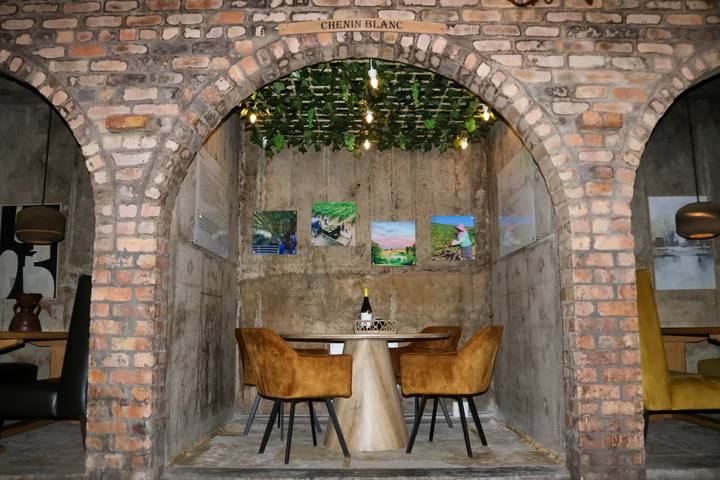 Brick archway tasting nook with a round table